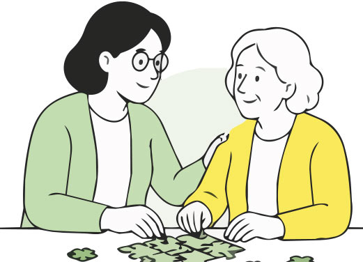 Junge und ältere Frau puzzeln gemeinsam am Tisch